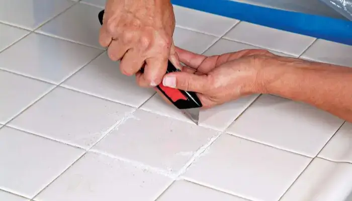 Trim the excess dried epoxy near the crack. / how to repair cracks on floor tile?