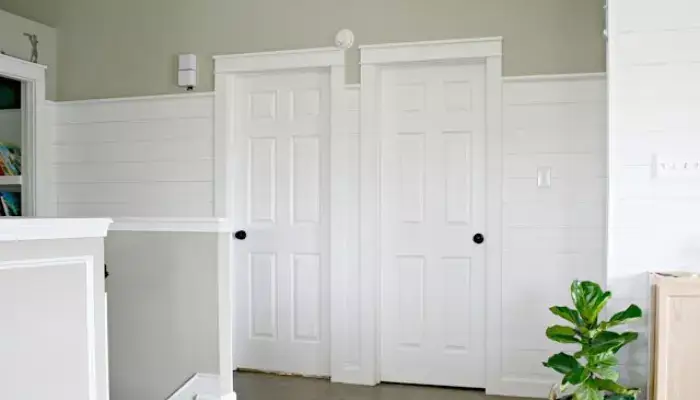 Farmhouse-style door casing with shiplap or beadboard accents / styles of door casing