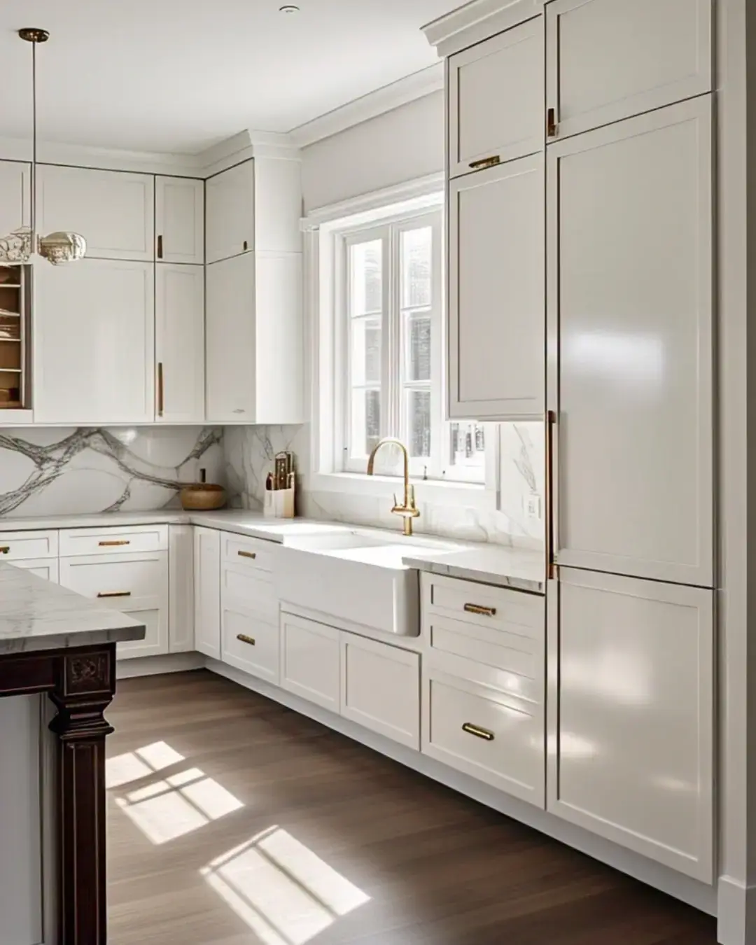 Kitchen Cabinet Colors for White Tile Floors: 11 Best Ideas and Expert Tips 2 Kitchen Cabinet Colors for White Tile Floors, A minimalist, airy kitchen with a bright color scheme. The room has sleek white cabinets with a few dishes inside. The floor is made up of patterned white tiles. A marble countertop is positioned next to the cabinets. A few items, including a toaster, a kettle, and a few bottles, are placed on the countertop. The room has a window with white curtains and a light fixture hanging from the ceiling.
