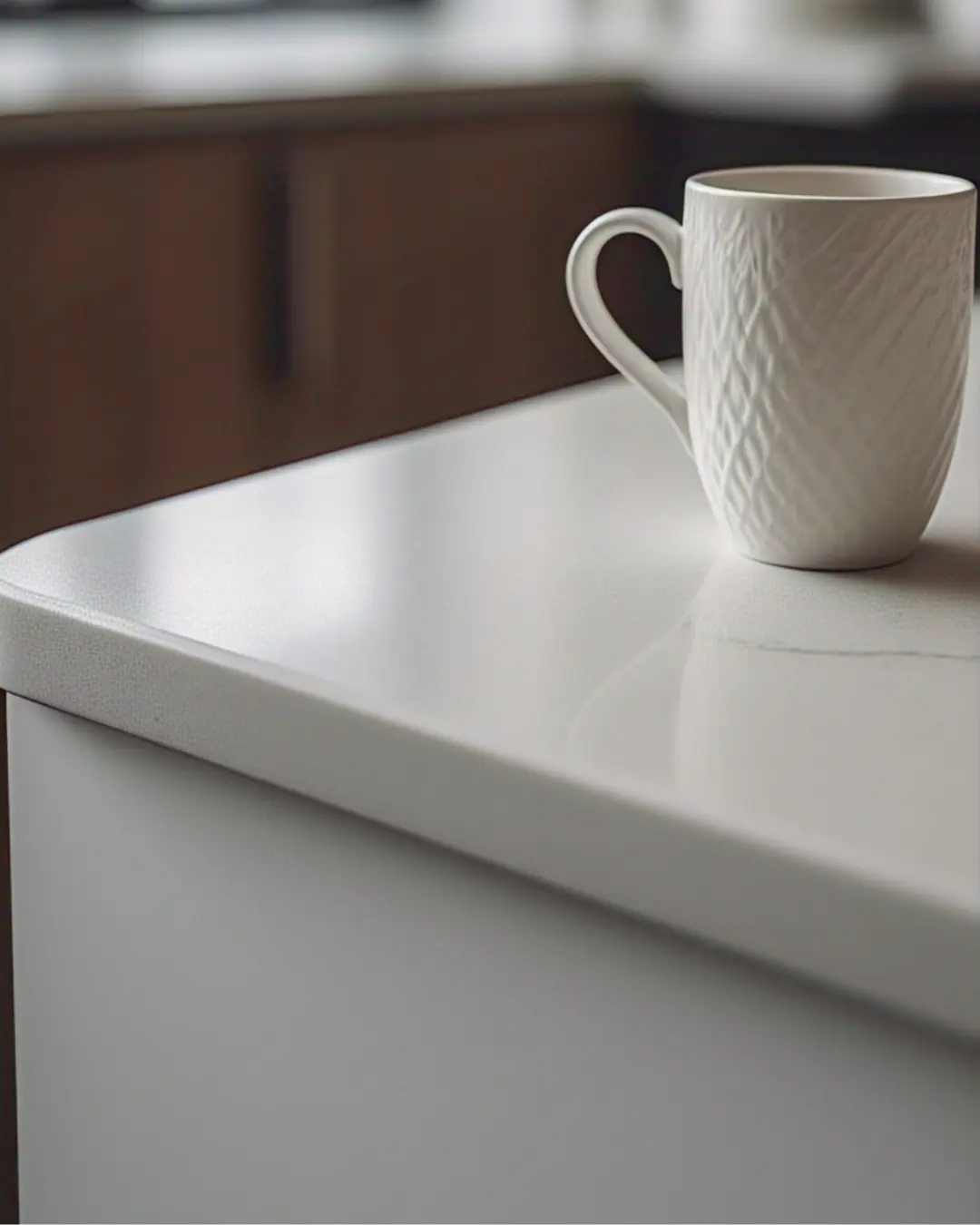 Half-Bullnose Edge Countertops: The “Just Right” Rounded Corner 2 Half-Bullnose Edge Countertops / Close-up of a half-bullnose edge on a white countertop—smooth on top, sharp on the bottom—with a coffee cup resting on it.