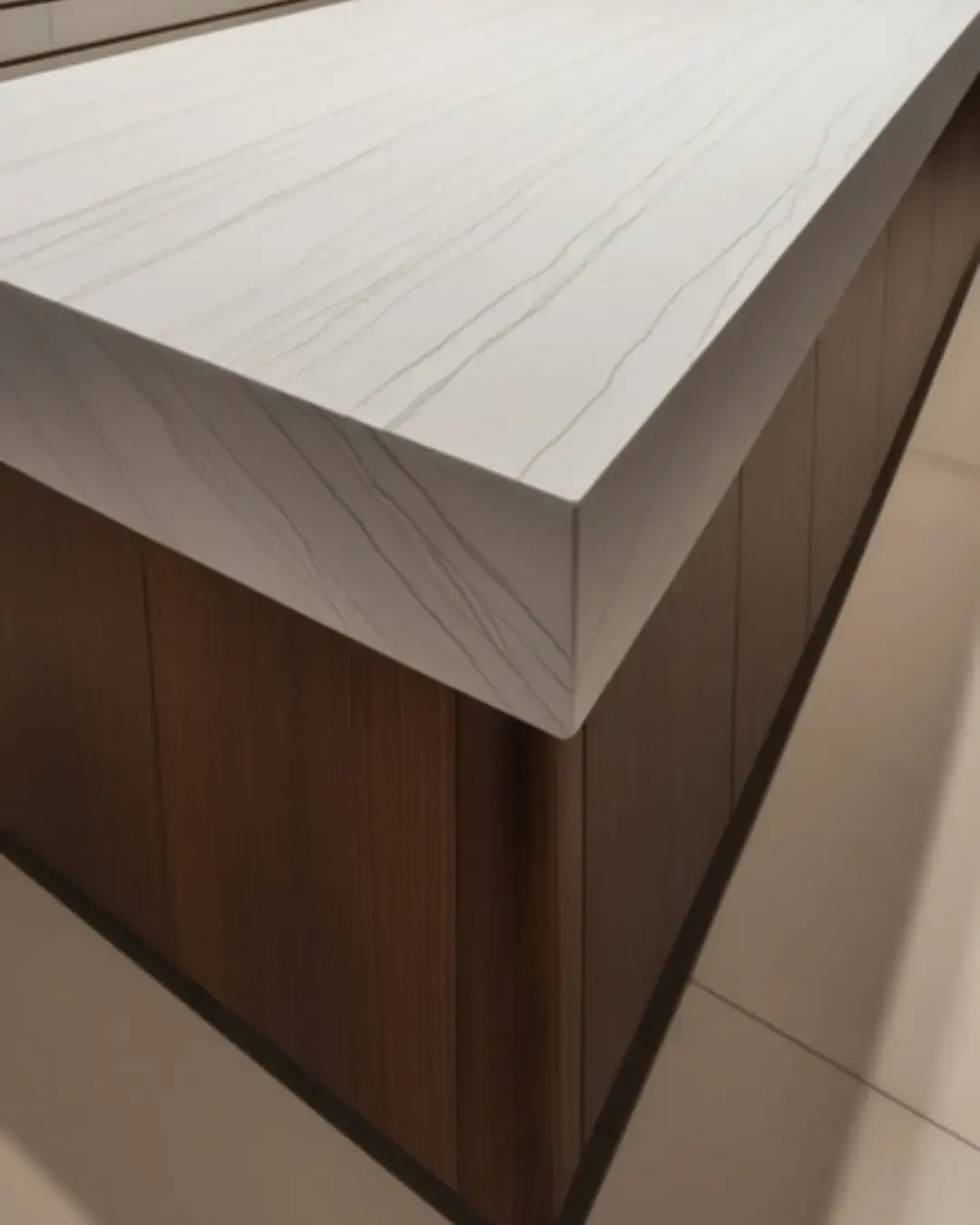 A mitered-edged marble countertop in a contemporary kitchen, with precision-cut corners creating a thick, bold look in a modern space.